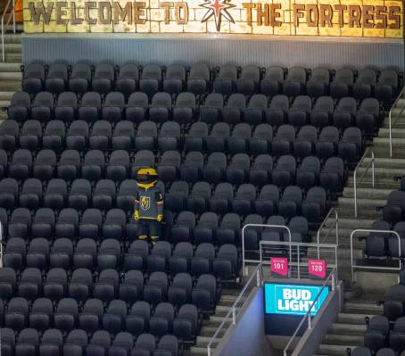 Vegas Golden Knights mascot Chance stands in the middle of empty seats during the third period ...