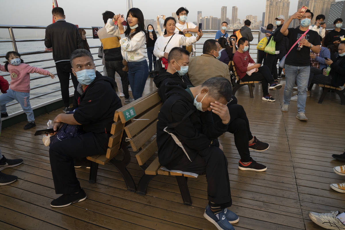 Residents, some wearing masks, ride on a ferry in Wuhan on Thursday, Oct. 22, 2020. The global ...