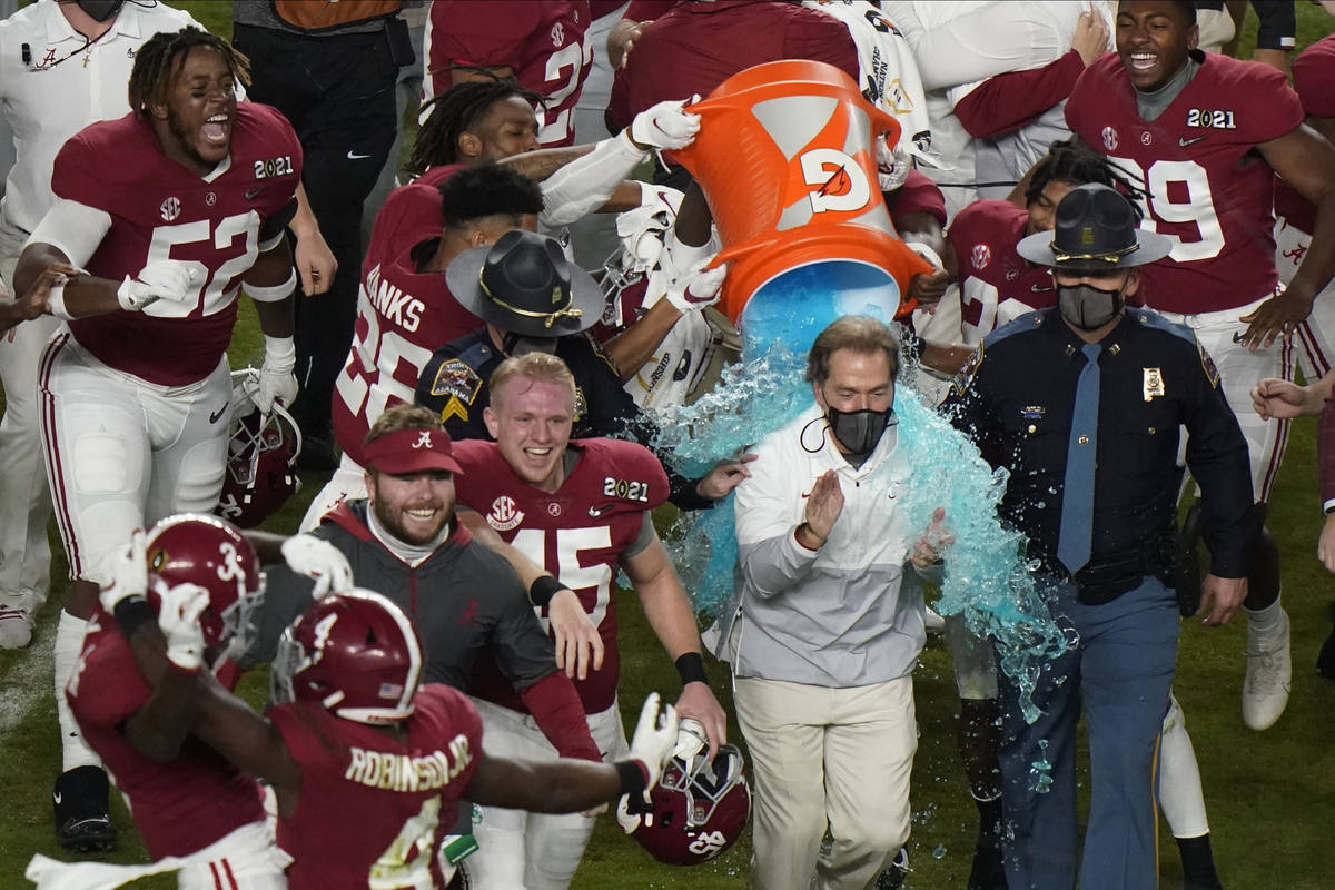 Alabama head coach Nick Saban is soaked in a sports drink after their win against Ohio State in ...