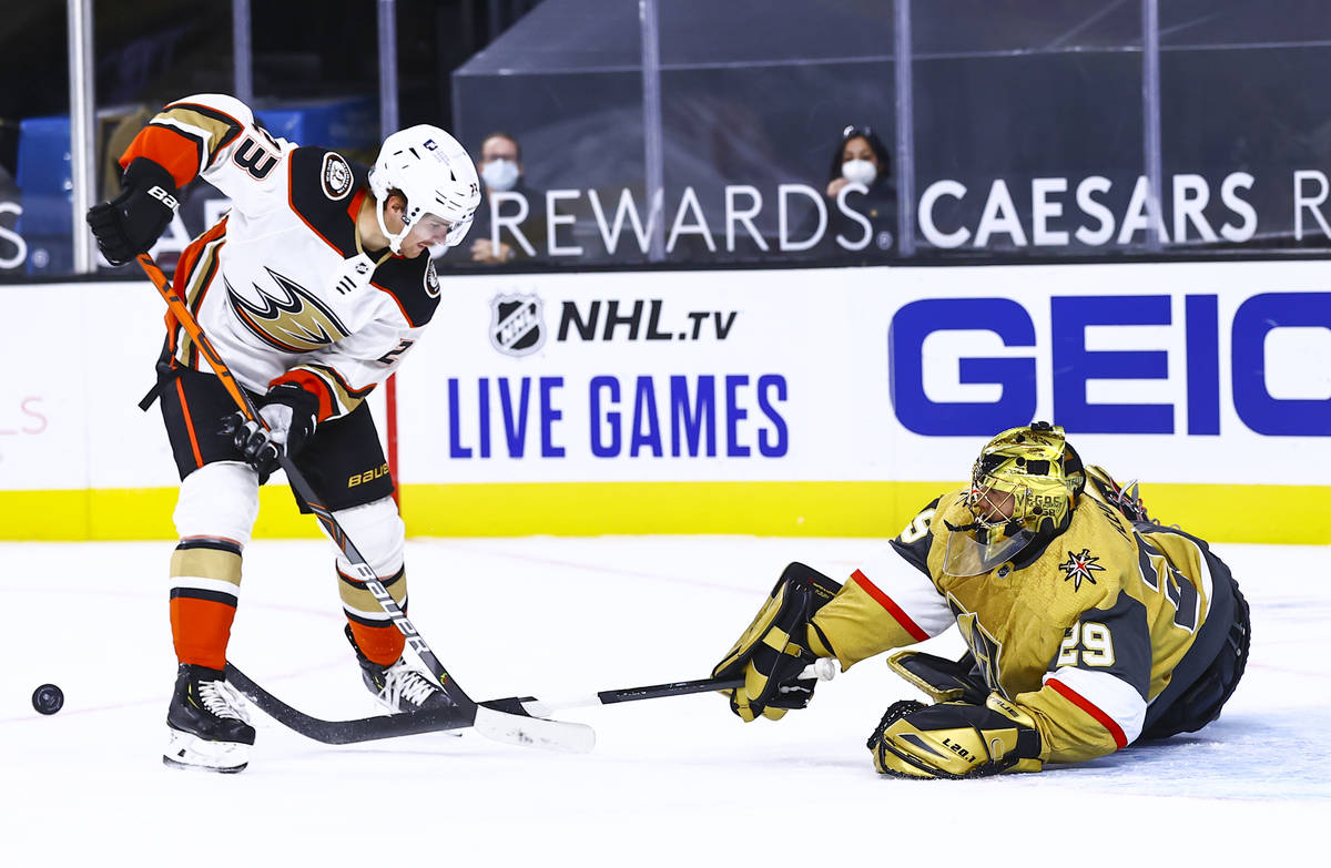 Golden Knights goaltender Marc-Andre Fleury (29) knocks the puck away from Anaheim Ducks center ...