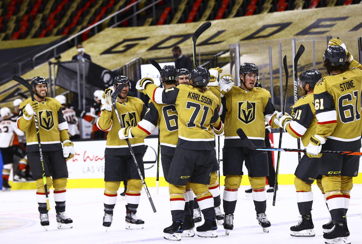 The Golden Knights celebrate after their overtime win against the Anaheim Ducks in an NHL hocke ...