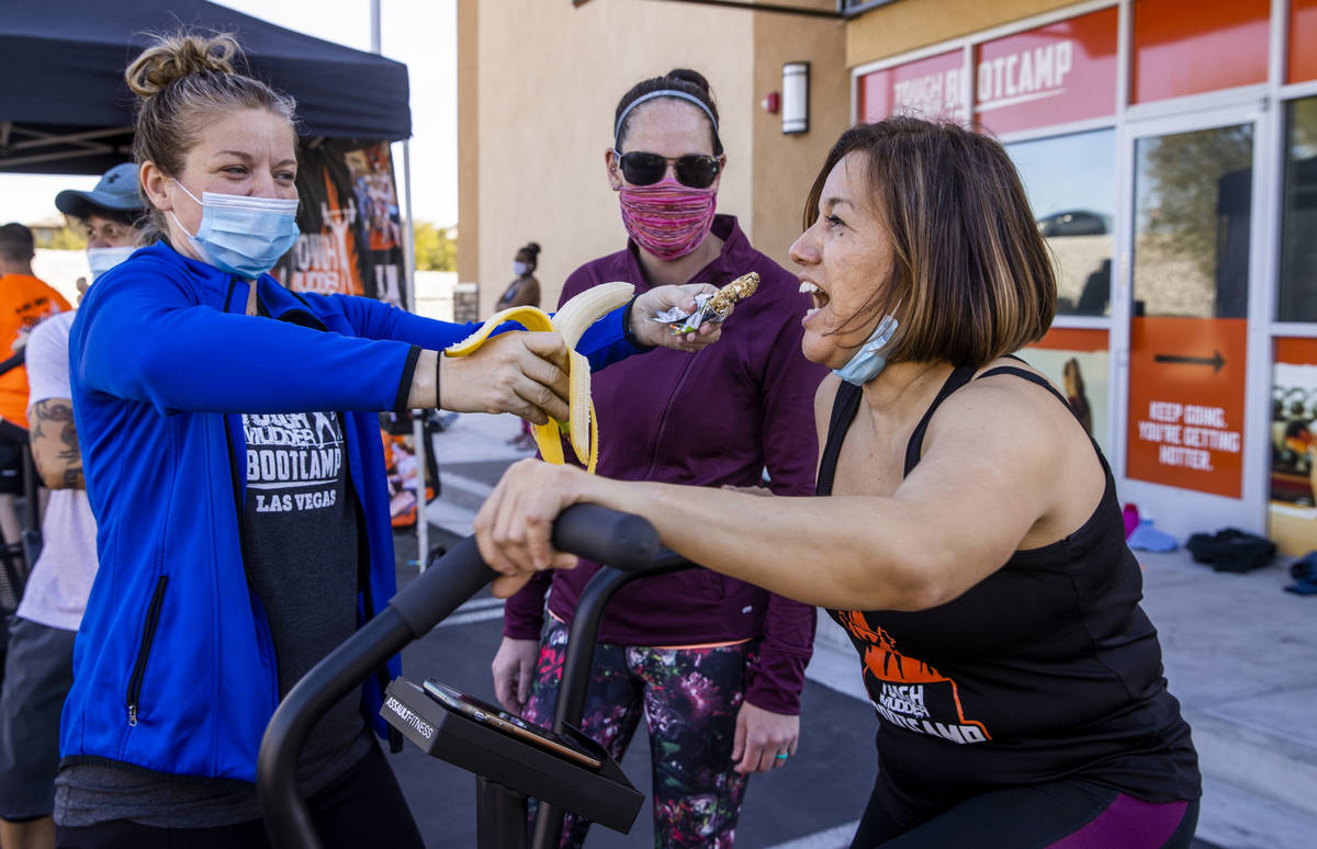 Yanet Martinez, right, is offered a choice of granola bar or banana while pedaling from Sandy R ...