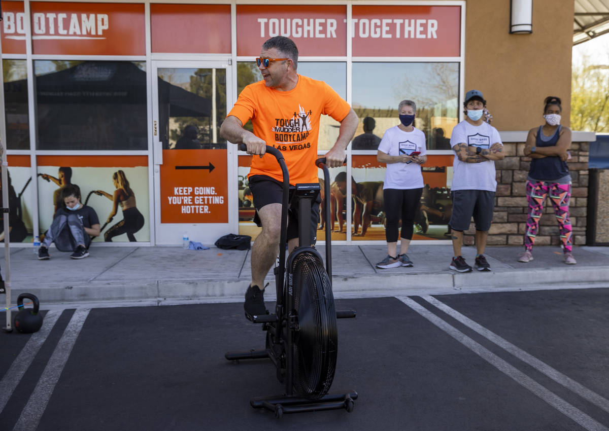 Co-owner Cory Drumright pedals some miles as Tough Mudder Bootcamp Las Vegas members pedal 96 m ...