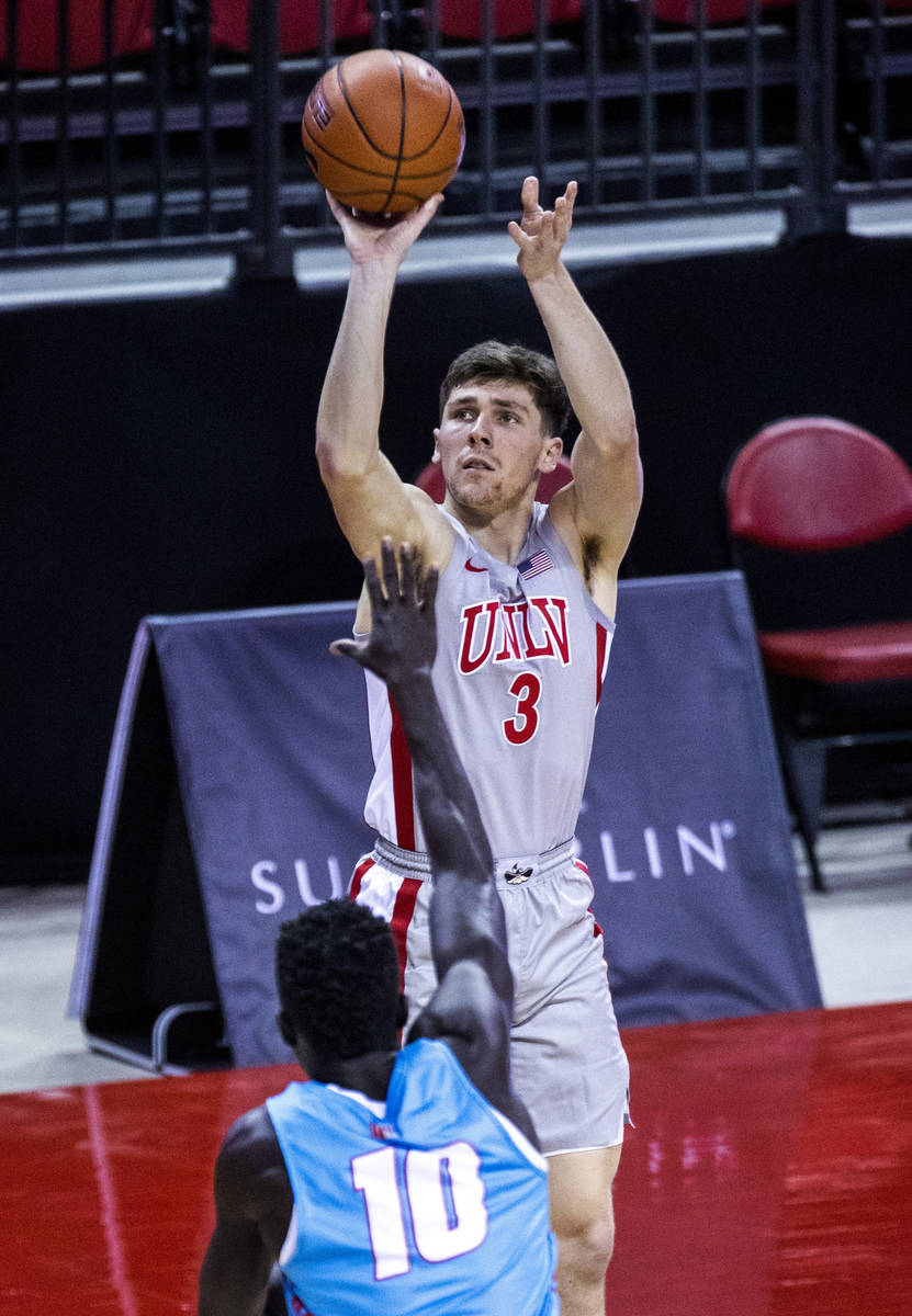 UNLV Rebels guard Caleb Grill (3) shoots another 3-point basket over New Mexico Lobos guard Mak ...