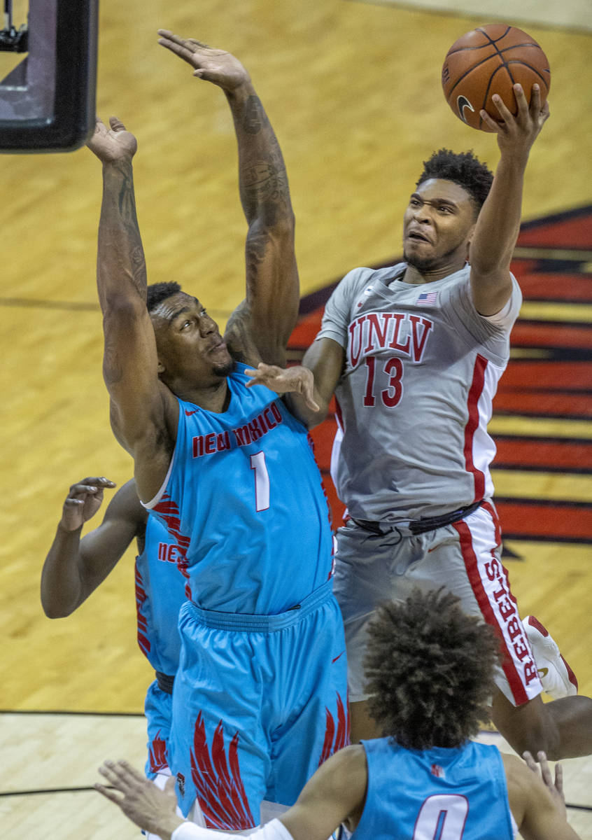 UNLV Rebels guard Bryce Hamilton (13) goes up to the net strong versus New Mexico Lobos forward ...