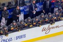 Vegas Golden Knights head coach Pete DeBoer, back center, holds his water bottle as he coaches ...