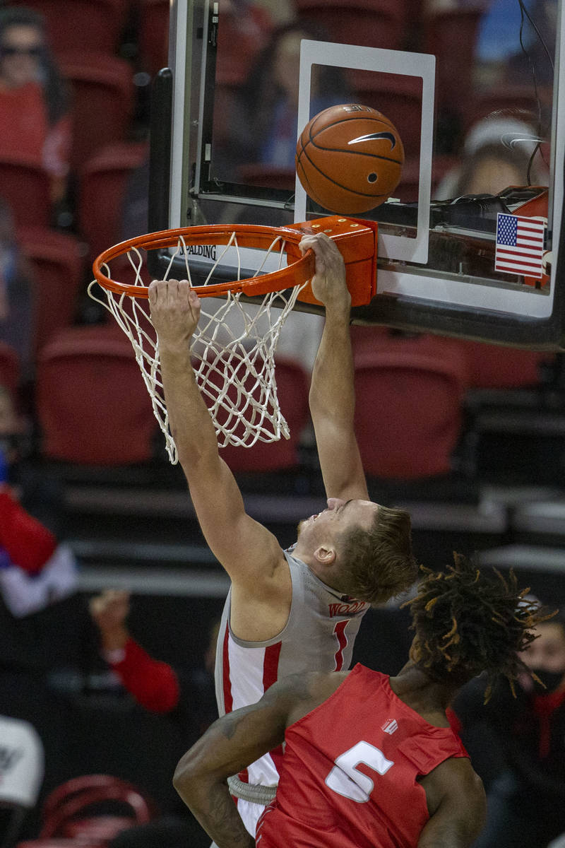 UNLV Rebels forward Moses Wood (1) misses on a dunk as New Mexico Lobos forward Rod Brown (5) d ...
