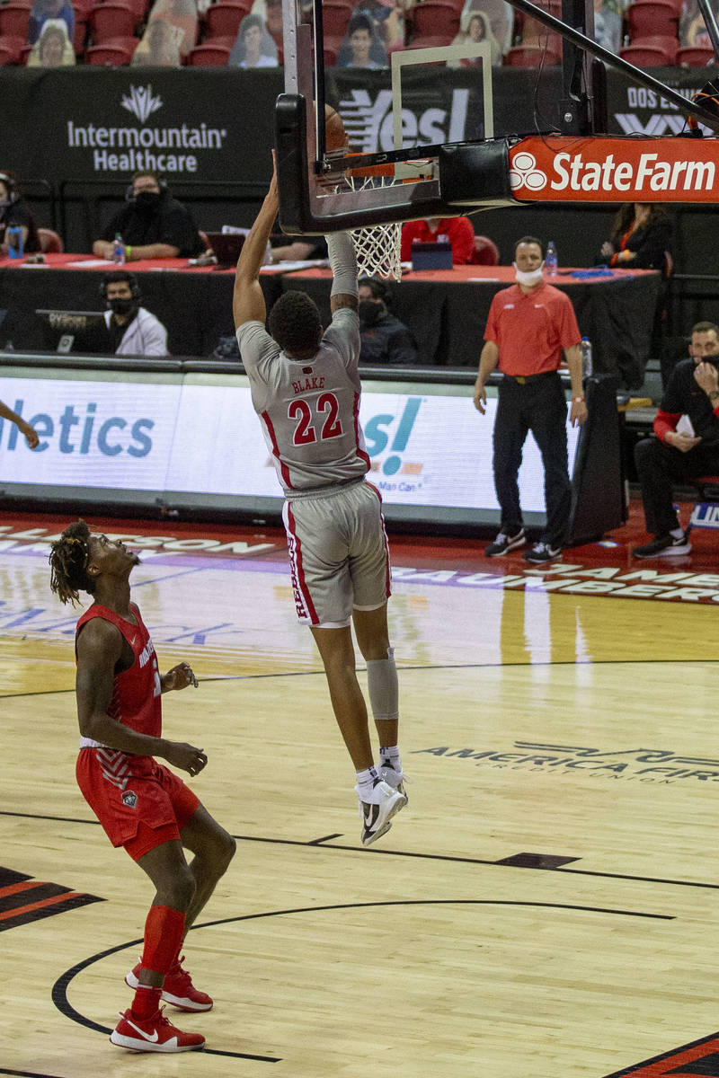 UNLV Rebels guard Nick Blake (22) goes up backwards to dunk the ball in the hoop against New Me ...