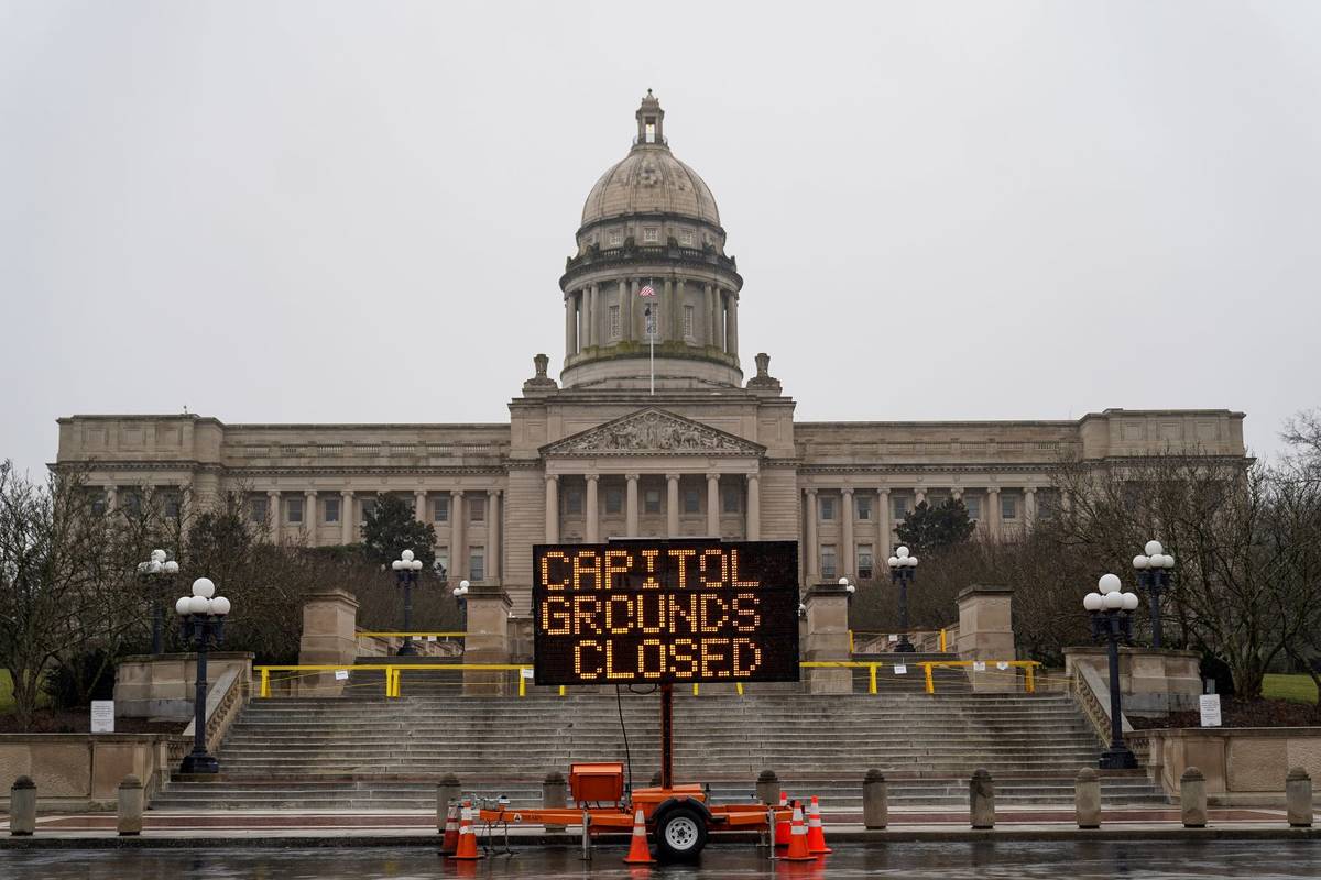 A sign displayed outside the Capitol building in Frankfort, Ky., advises that the grounds are c ...