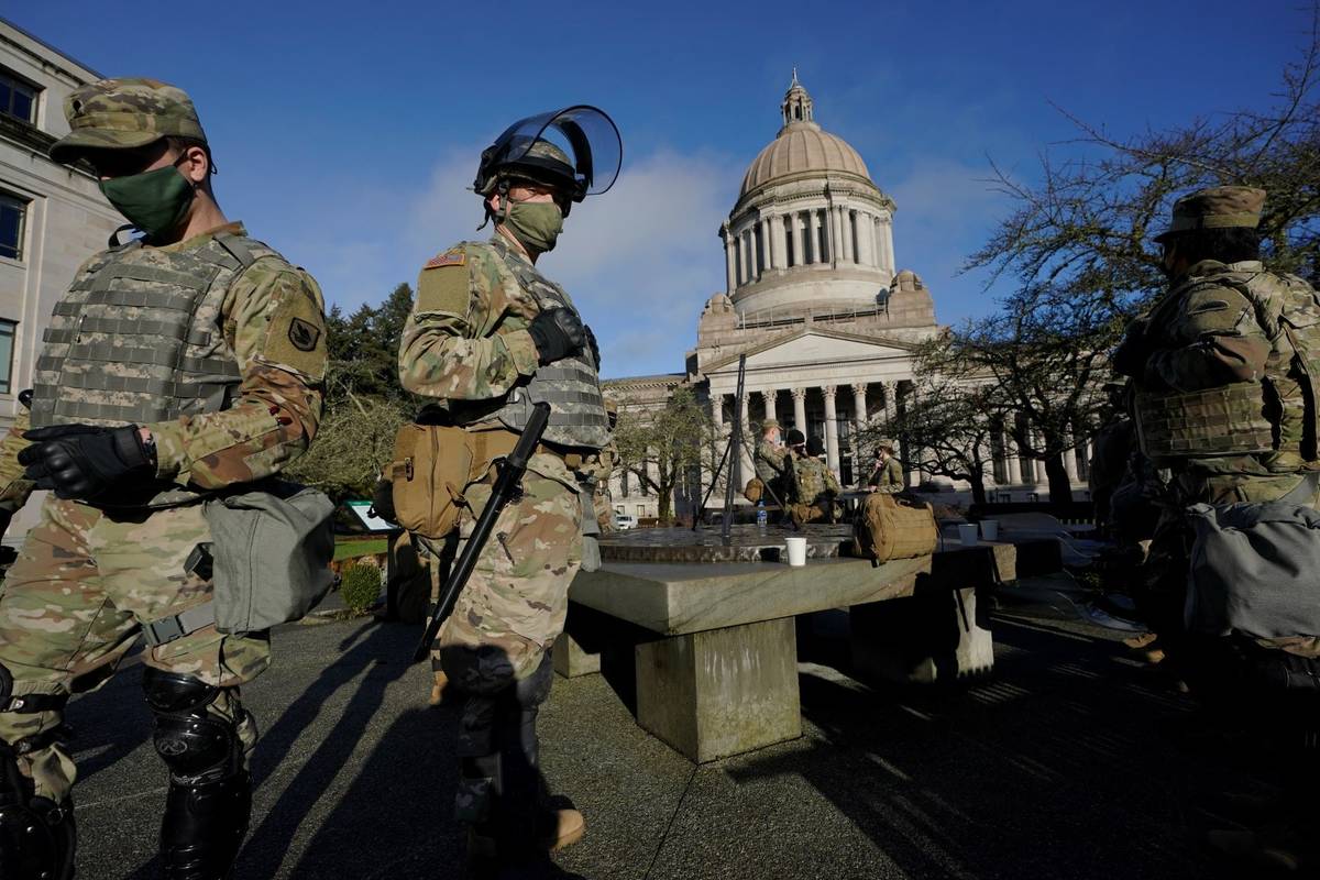 Members of the Washington National Guard stand at a sundial near the Legislative Building, Sund ...