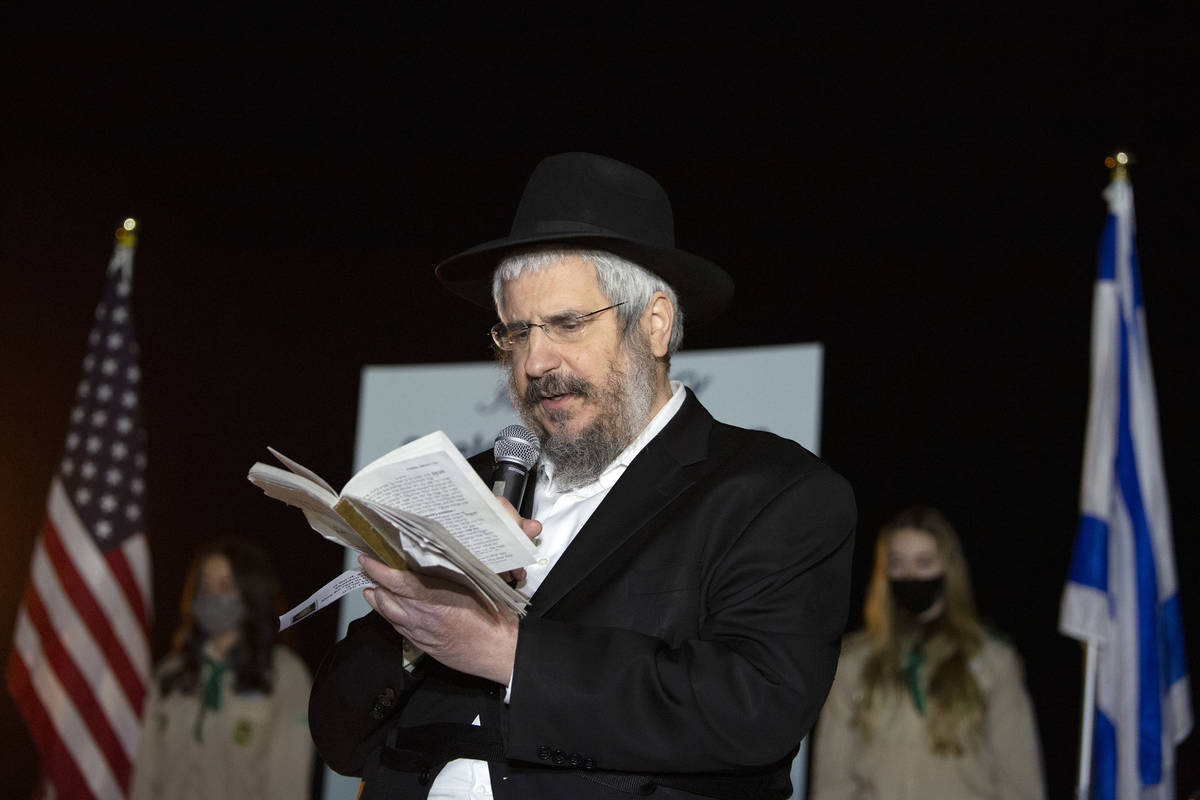 Rabbi Shea Harlig of Chabad of Southern Nevada reads Psalms during a tribute to the late Sheldo ...