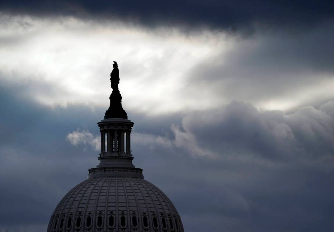The Statue of Freedom by Thomas Crawford, atop the dome of the U.S. Capitol, is shown ahead of ...