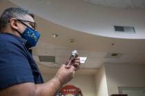 The North Las Vegas Fire Department health care coordinator Fernando Juarez fills a syringe wit ...