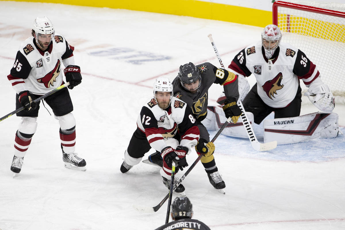 Golden Knights' right wing Alex Tuch (89) and Arizona Coyotes' defenseman Jordan Oesterle (82) ...