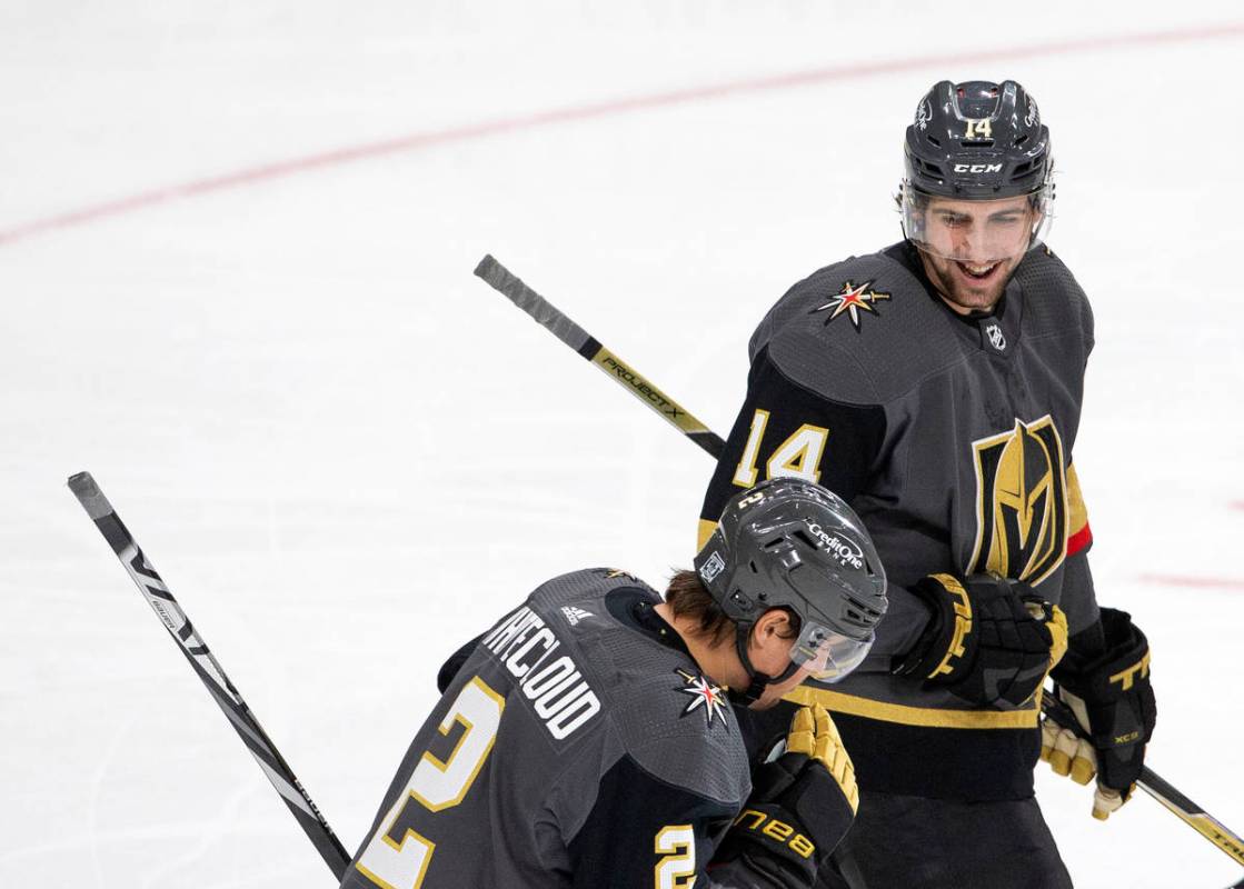 Golden Knights' defenseman Nicolas Hague (14) celebrates with defenseman Zach Whitecloud (2) af ...