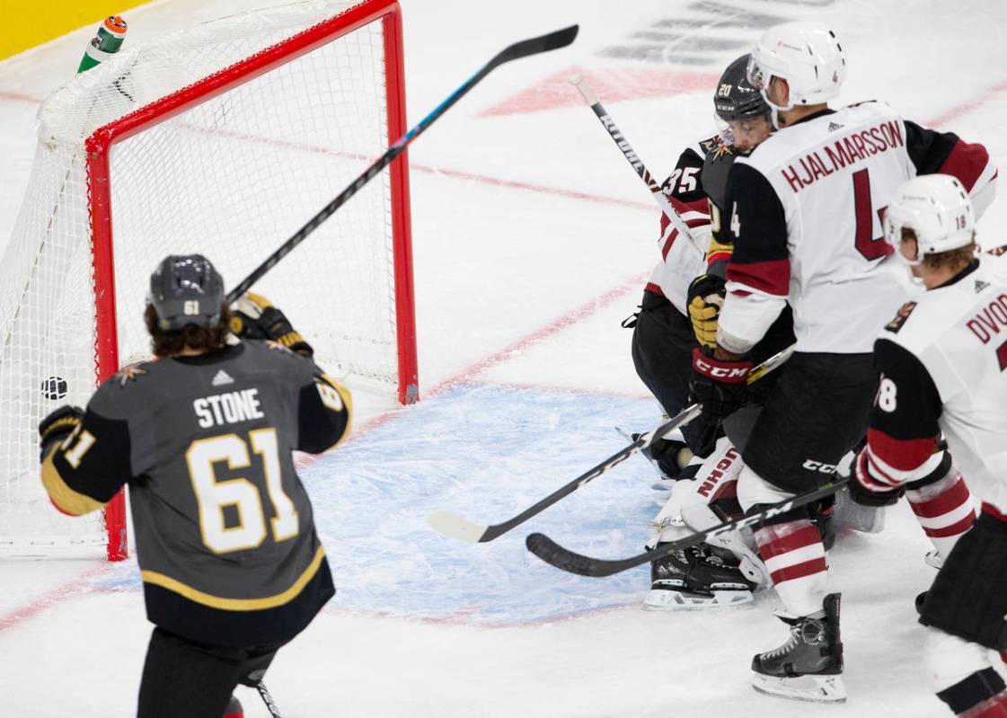 Golden Knights' center Chandler Stephenson (20) scores a goal against the Arizona Coyotes durin ...