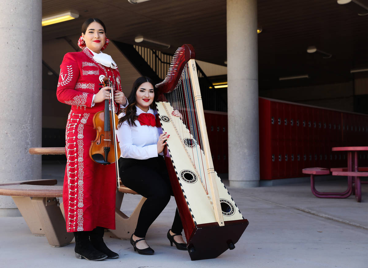 Michelle Madrid, left, who plays the violin, and her twin sister, Rachelle, who plays the harp, ...