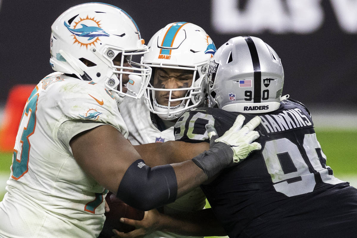Miami Dolphins quarterback Tua Tagovailoa (1) is sacked by Raiders defensive tackle Johnathan H ...