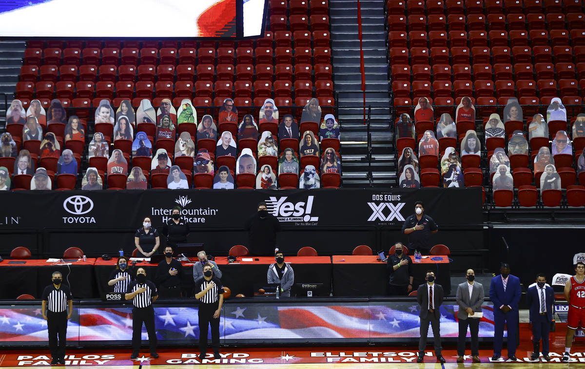 Officials stand for the national anthem before a basketball game between the UNLV Rebels and Be ...
