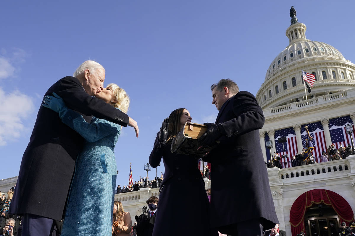 President Joe Biden kisses first lady Jill Biden, as his son Hunter Biden and daughter Ashley B ...