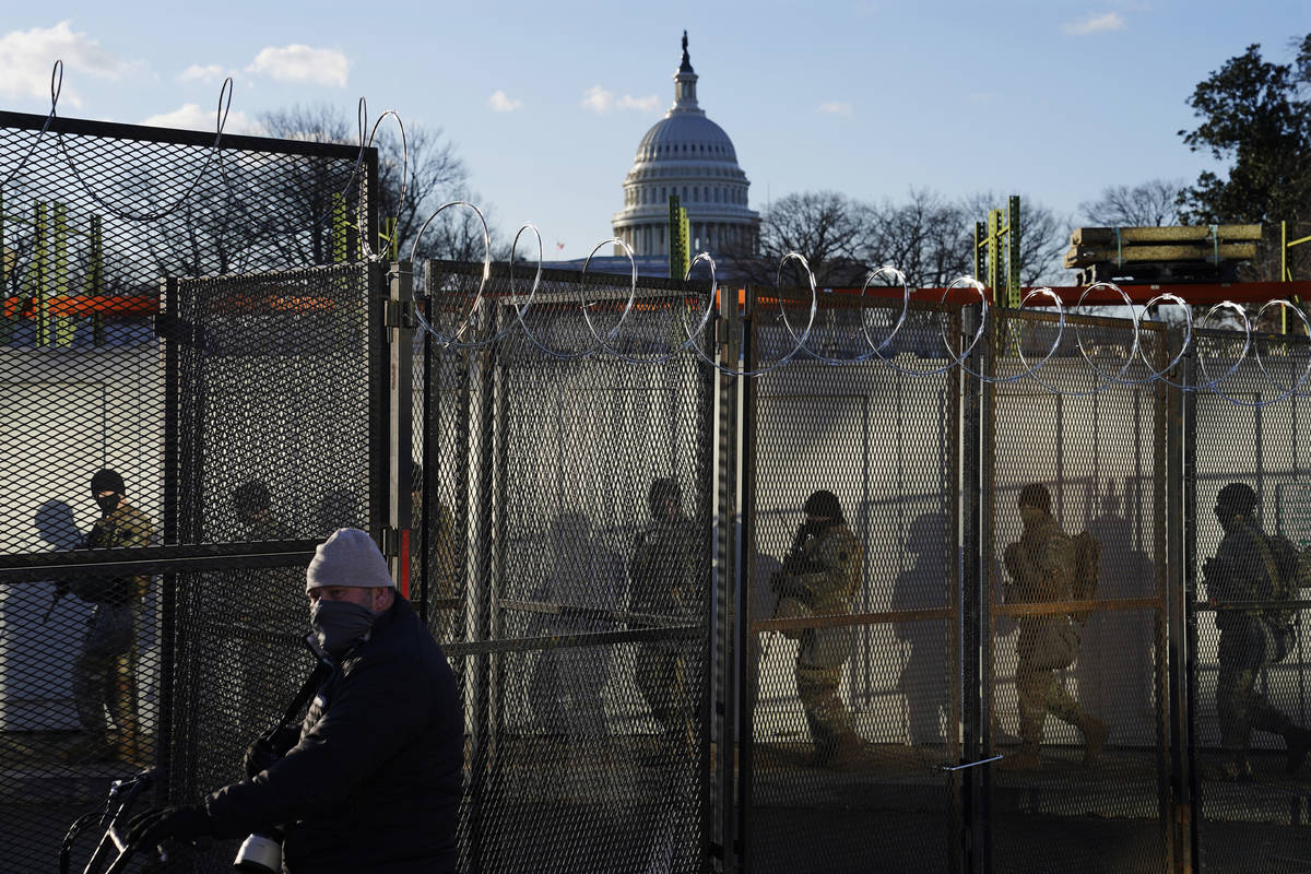 National Guards walk to the Capitol Building as events get underway for President-elect Joe Bid ...