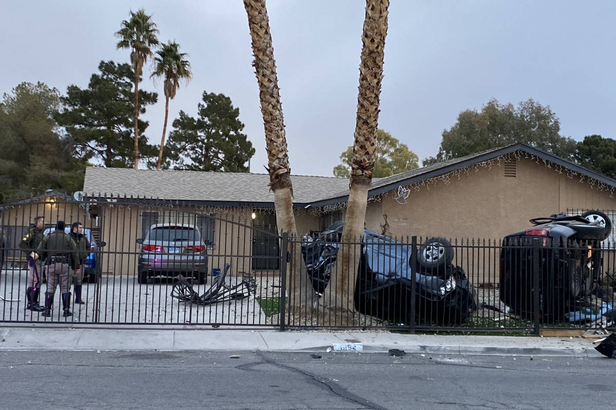 Las Vegas police are trying to determine how two vehicles ended up overturned in the front yard ...
