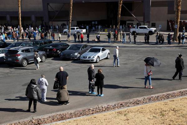 People wait in line to get the COVID-19 vaccine at the Cashman Center in Las Vegas, on Wednesda ...