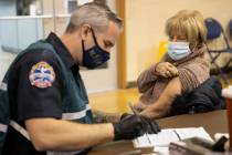 Lynne Lober, 70, waits to receive the COVID-19 vaccine from Nathan Van Wingerden, paramedic for ...