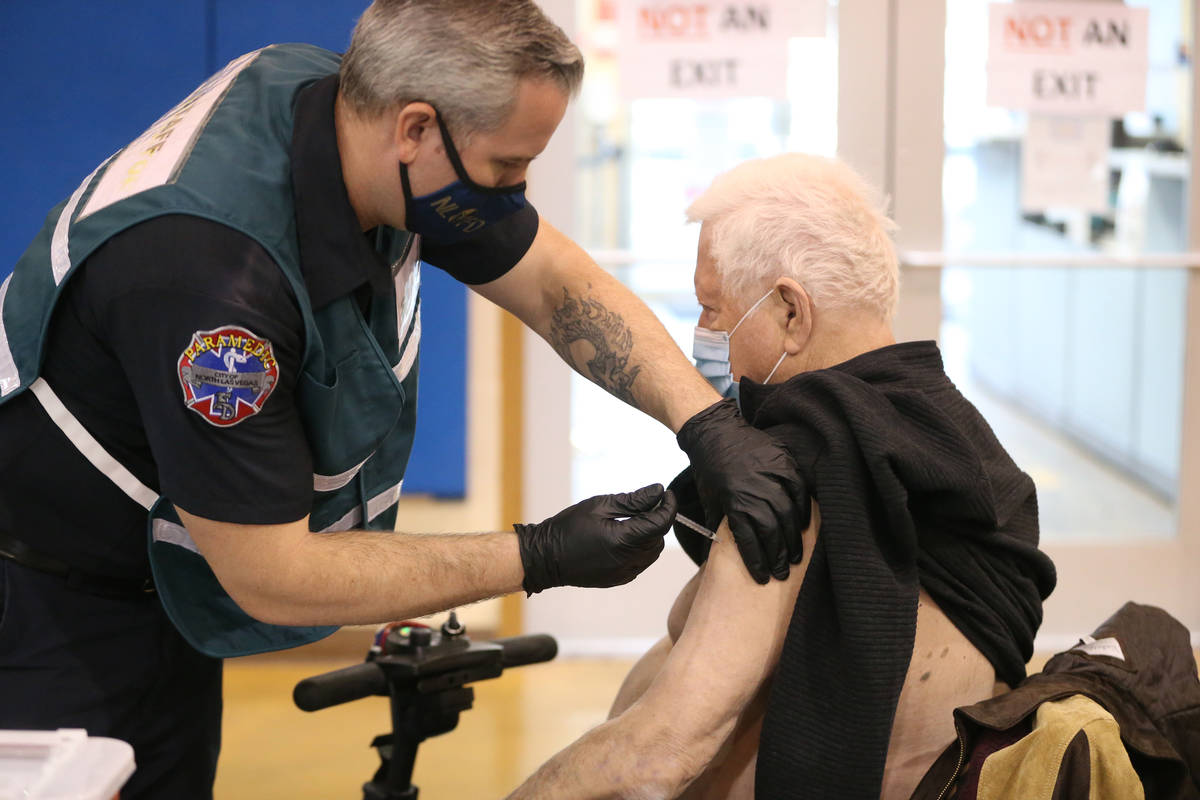 Richard Lober, 79, receives the COVID-19 vaccine from Nathan Van Wingerden, paramedic for the N ...