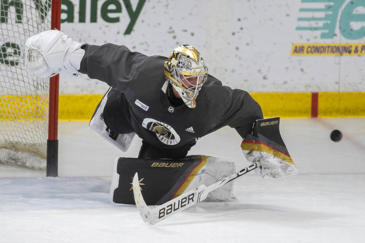 Golden Knights goaltender Logan Thompson (36) makes an acrobatic save during practice at City N ...