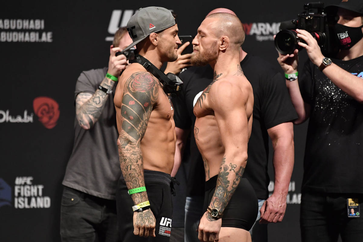 Opponents Dustin Poirier, left, and Conor McGregor of Ireland face off during the UFC 257 weigh ...