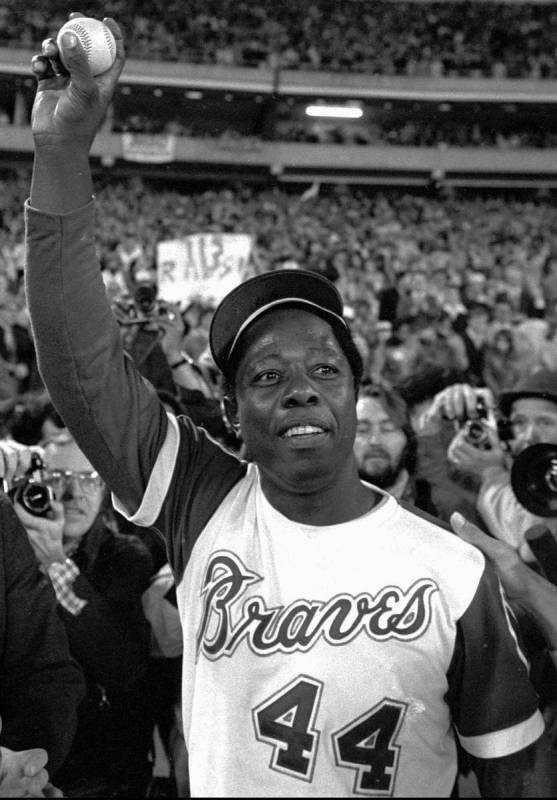 FILE - In this April 8, 1974, file photo, Atlanta Braves' Hank Aaron holds aloft the ball he hi ...