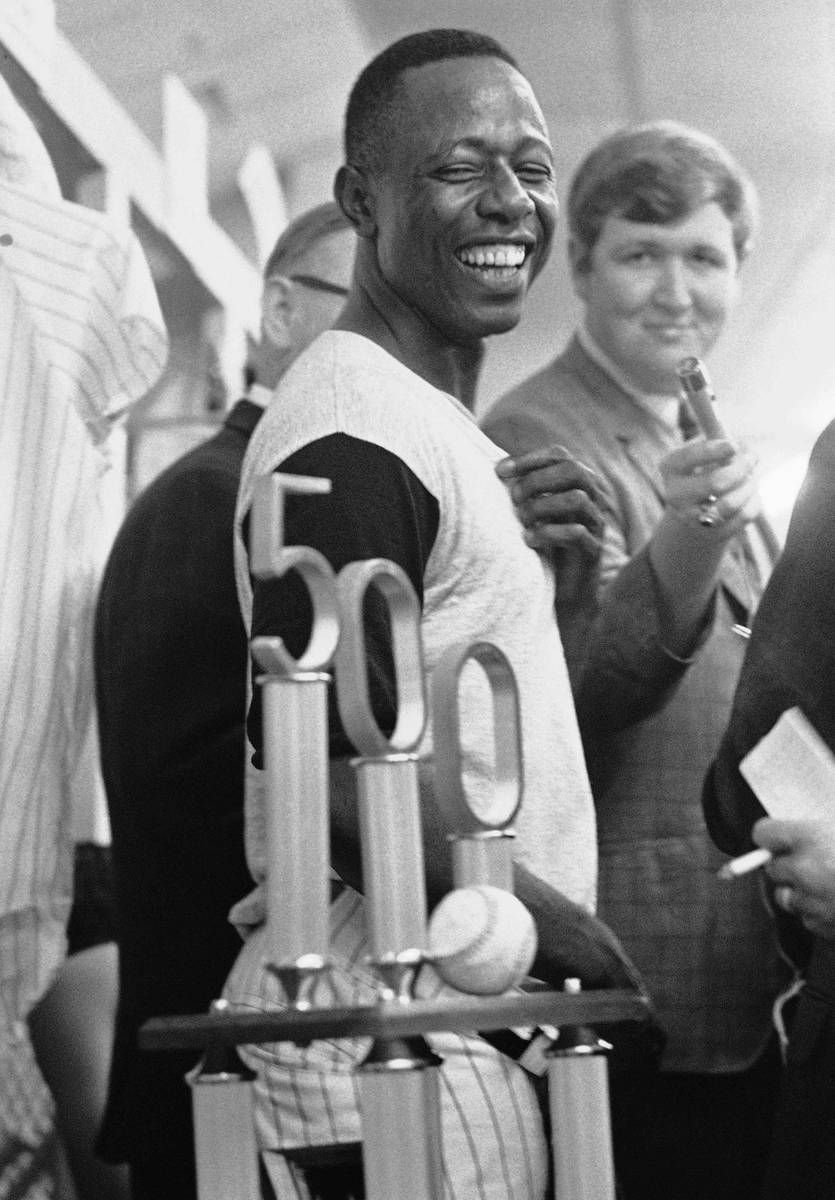 FILE- In this July 14, 1968, file photo, Atlanta Braves' Hank Aaron smiles as he looks at the t ...