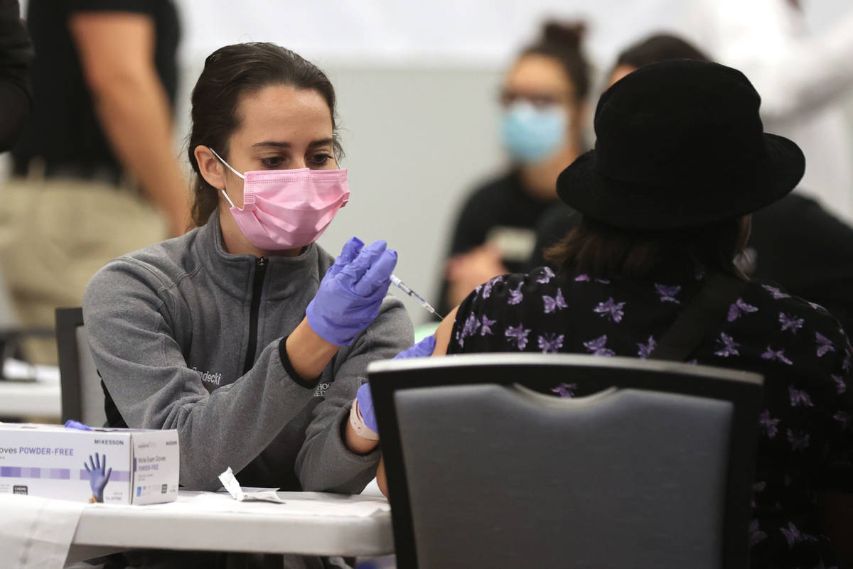 Ashley Prandecki, a medical student at UNLV School of Medicine, gives a COVID-19 vaccine during ...
