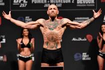 Conor McGregor of Ireland poses on the scale during the UFC 257 weigh-in at Etihad Arena on UFC ...