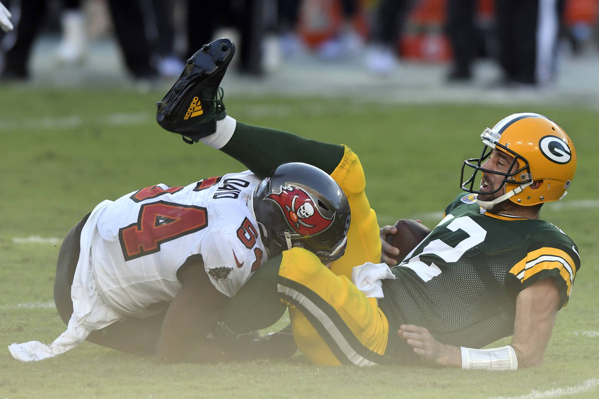 Green Bay Packers quarterback Aaron Rodgers (12) gets sacked by Tampa Bay Buccaneers inside lin ...