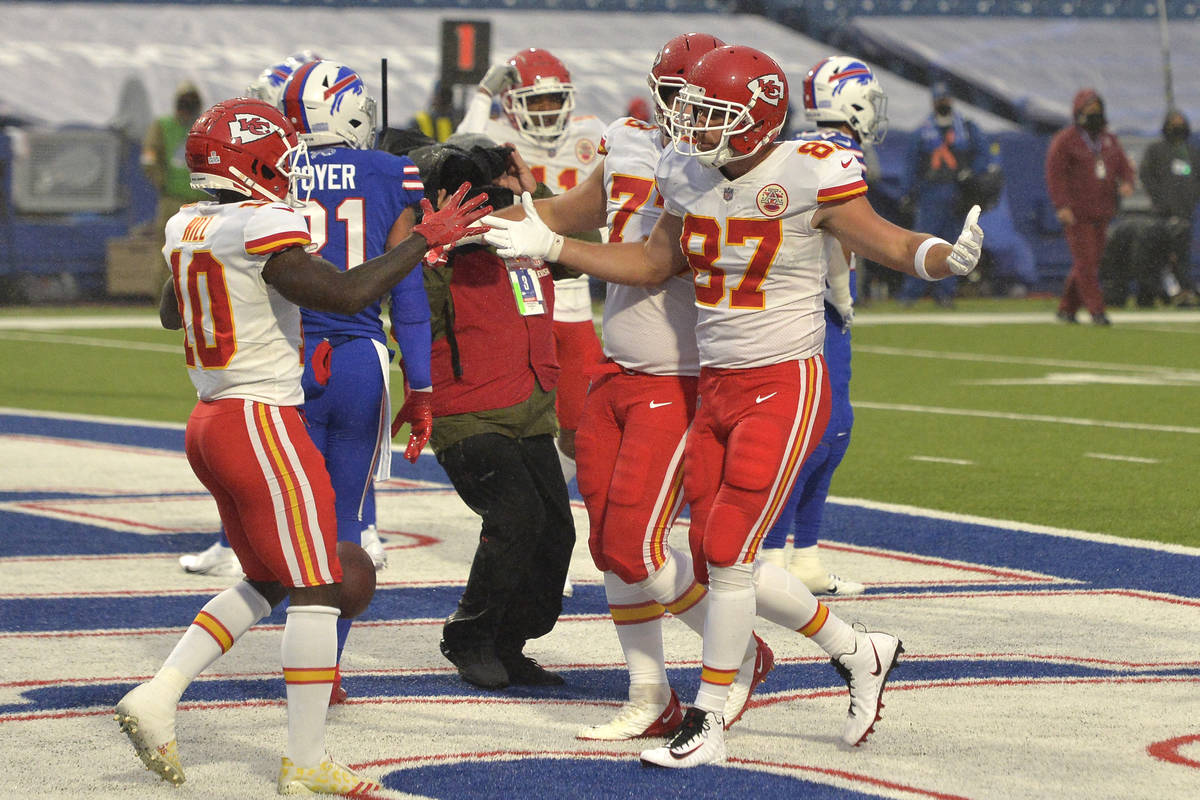 Kansas City Chiefs' Travis Kelce (87), right, celebrates a touchdown during the first half of a ...