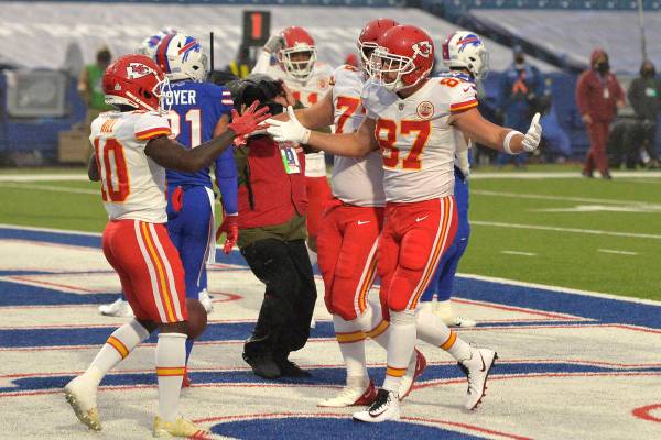 Kansas City Chiefs' Travis Kelce (87), right, celebrates a touchdown during the first half of a ...
