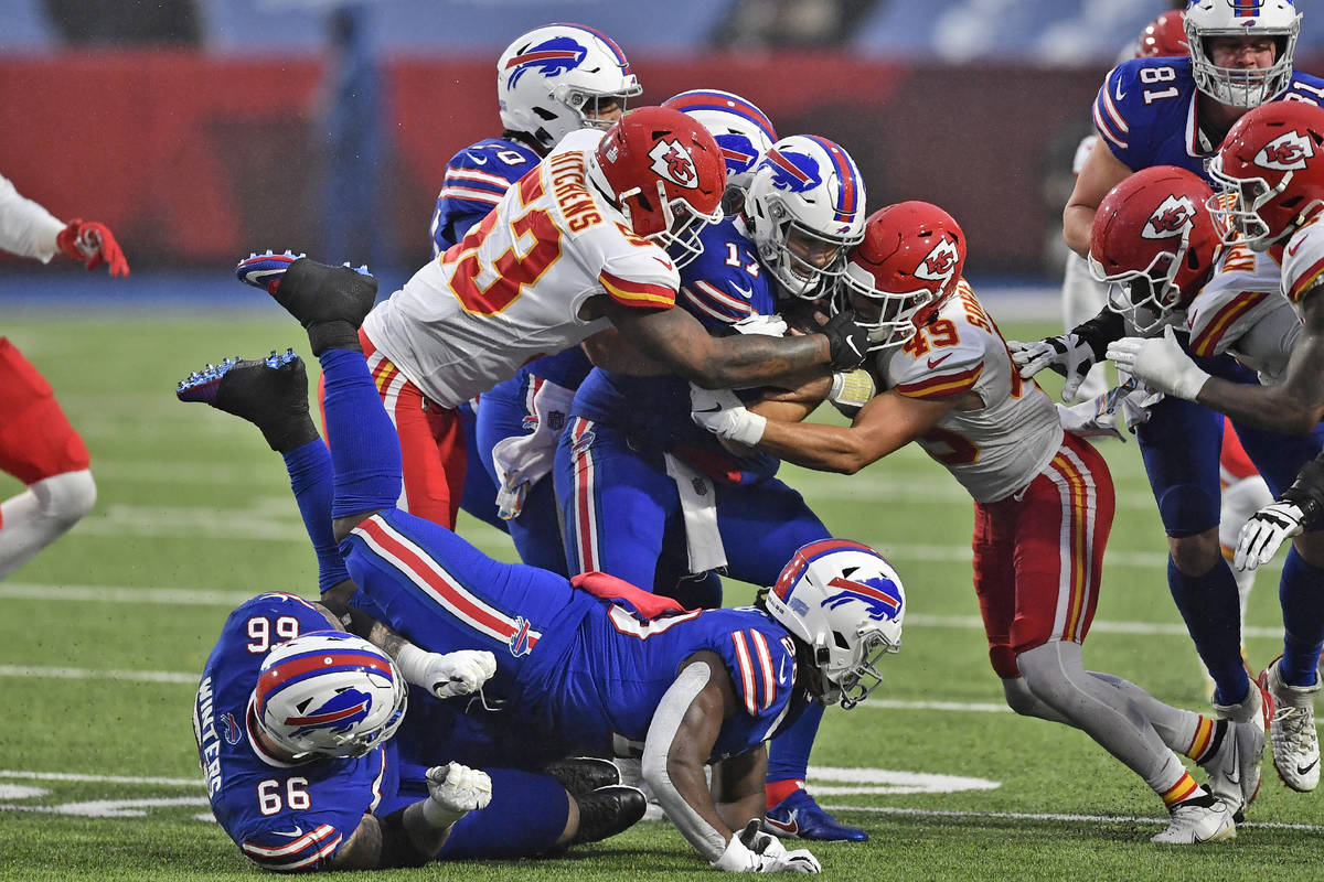 The Kansas City Chiefs defense tackles Buffalo Bills quarterback Josh Allen, center, during the ...