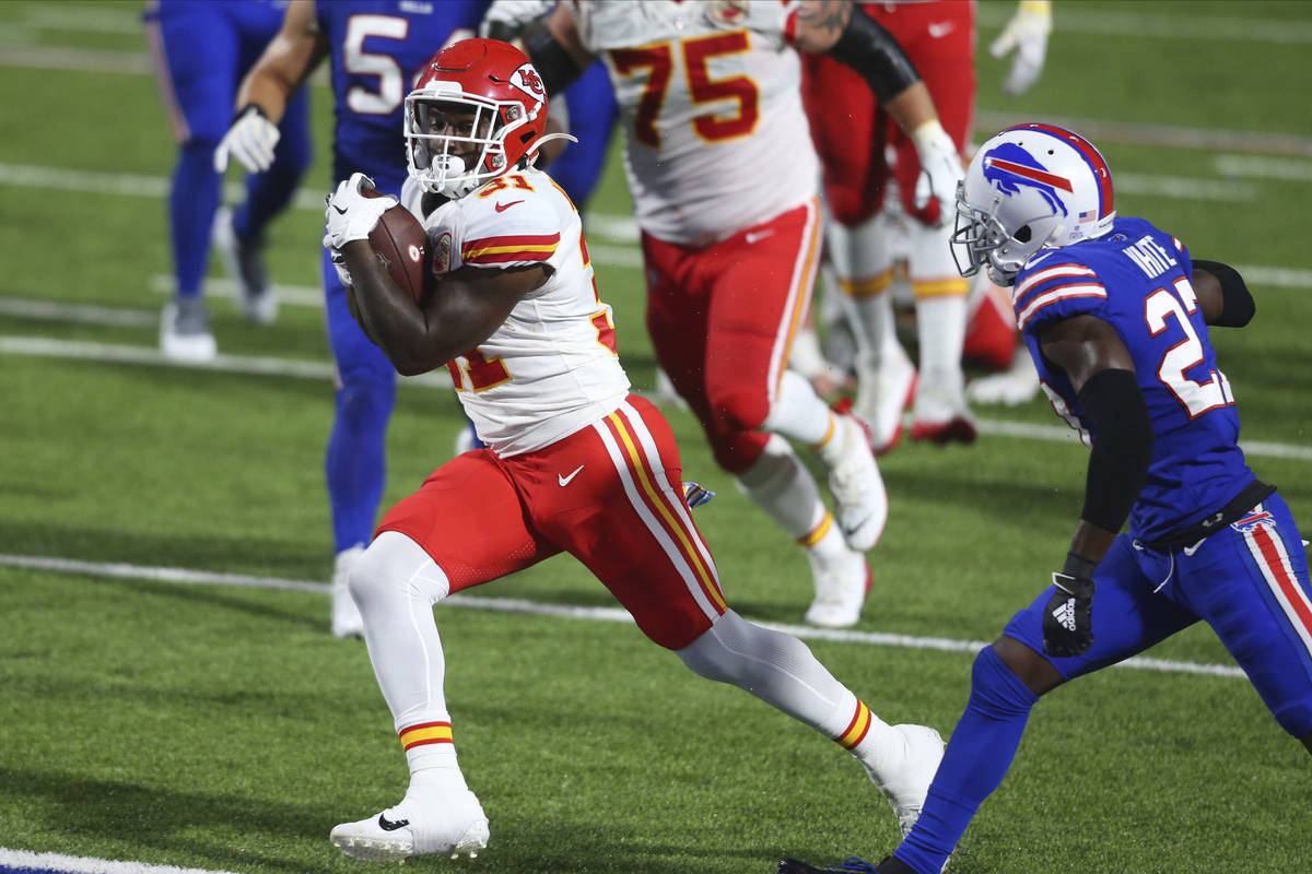 Kansas City Chiefs' Darrel Williams, left, runs the ball for a touchdown while Buffalo Bills' T ...