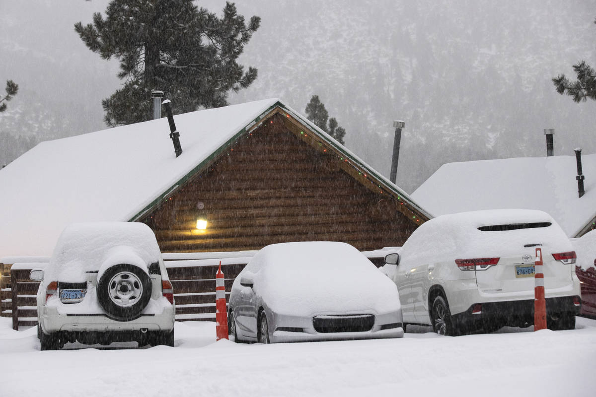 Snow covered cars are seen at The Charleston Lodge, on Monday, Jan. 25, 2021, in Mount Charlest ...
