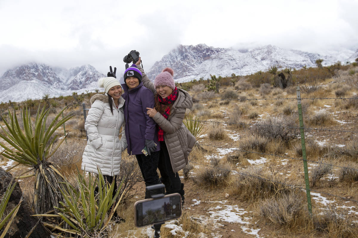 Tina Fang, left, Jenet Lu and Angel Fang pose for a photo while enjoying the snow at Red Rock N ...