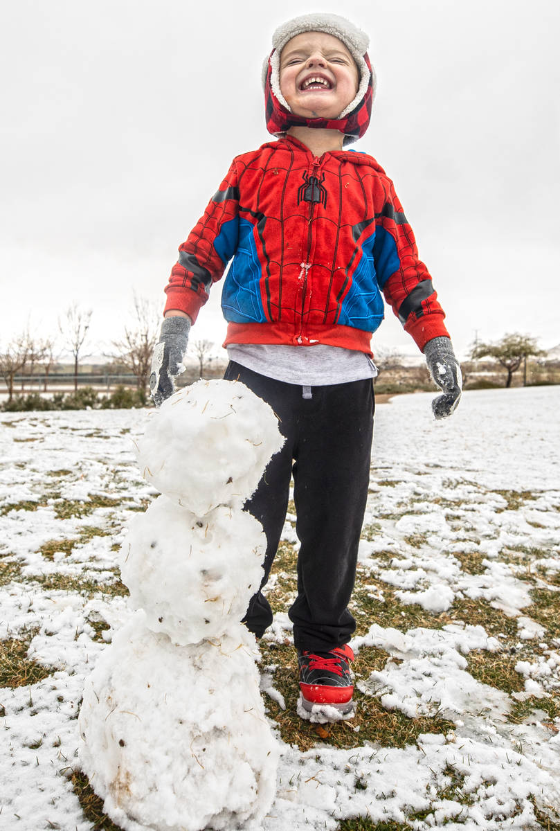Rowan Whitehead, 3, smiles after making a snowman at Knickerbocker Park on Monday, Jan. 25, 202 ...
