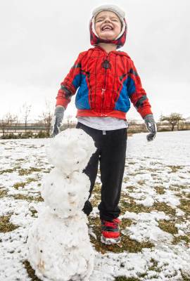 Rowan Whitehead, 3, smiles after making a snowman at Knickerbocker Park on Monday, Jan. 25, 202 ...