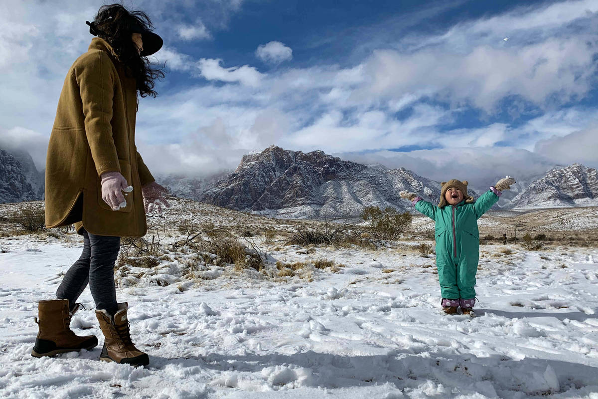 Ludia Kochan, of Las Vegas, plays in the snow with her son Jaxon Kochan (3) at Red Rock Canyon ...