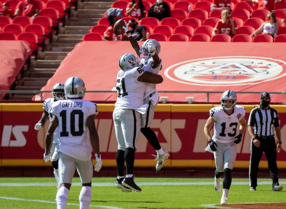 Las Vegas Raiders wide receiver Henry Ruggs III (11) celebrates his touchdown score with center ...
