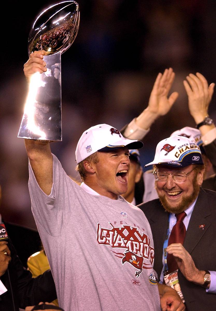 Tampa Bay Buccaneers head coach Jon Gruden, left, hoists the Vince Lombardi trophy as team owne ...