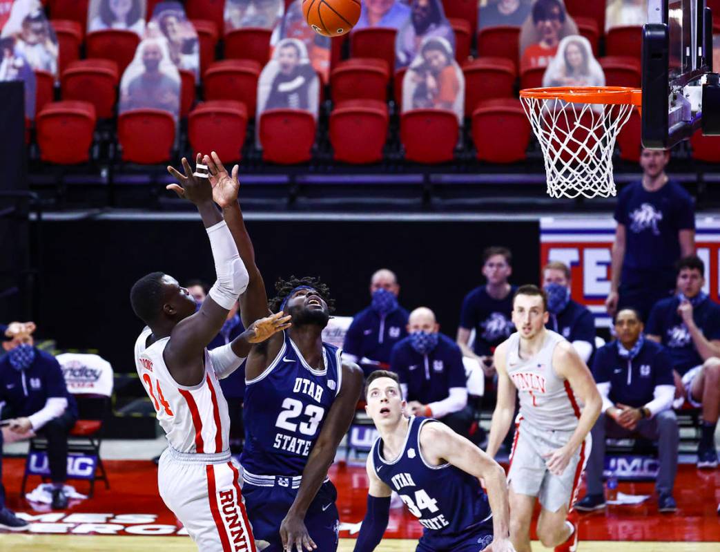 UNLV Rebels forward Cheikh Mbacke Diong (34) shoots over Utah State Aggies center Neemias Queta ...