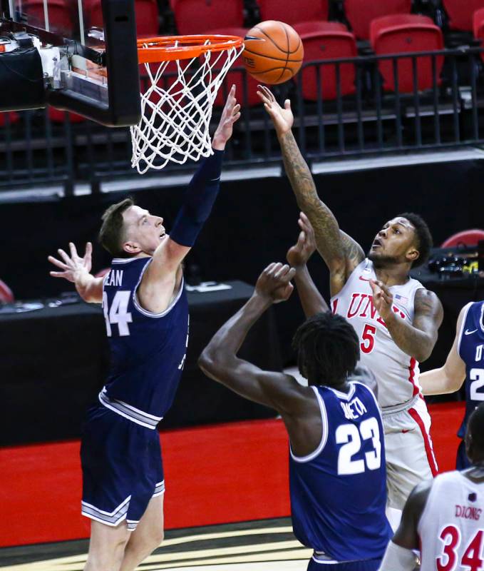 UNLV Rebels guard David Jenkins Jr. (5) attempts a shot under pressure from Utah State Aggies f ...