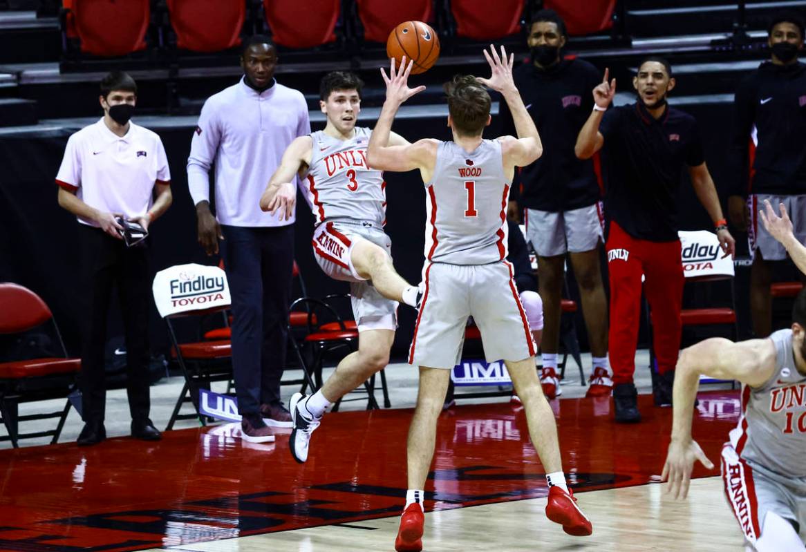 UNLV Rebels guard Caleb Grill (3) passes the ball to forward Moses Wood (1) during the first ha ...